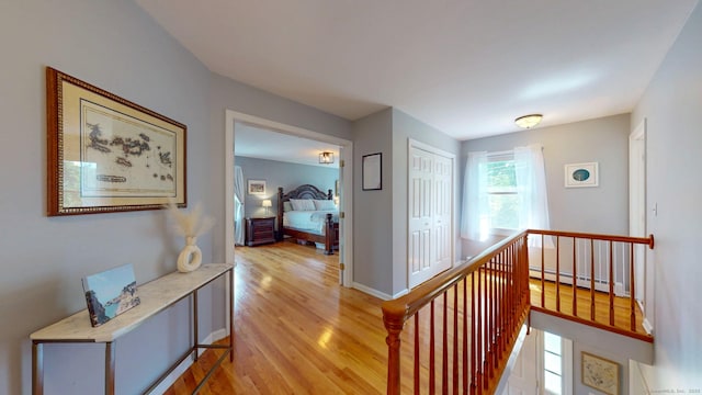 803 Grassy Hill Rd, Orange, CT 06477 - hallway with an upstairs landing, baseboard heating, and light wood-type flooring