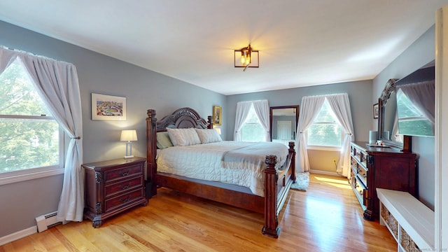 803 Grassy Hill Rd, Orange, CT 06477 - bedroom featuring a baseboard heating unit and light wood-style floors