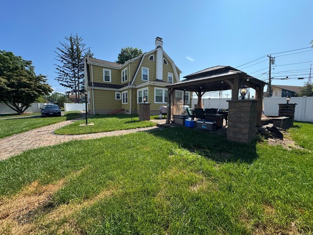 1589 Main St, East Hartford, CT 06108 - rear view of house with a gazebo and a chimney