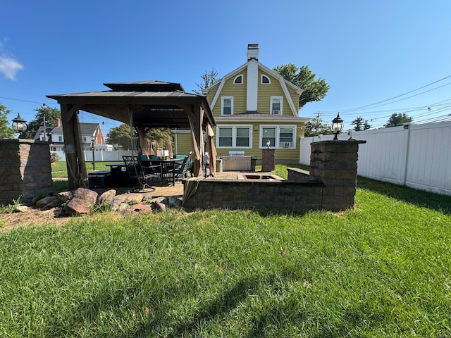 1589 Main St, East Hartford, CT 06108 - rear view of property featuring a gazebo, a chimney, a patio area, and a gambrel roof
