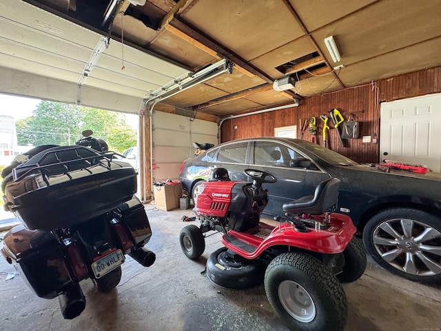 1589 Main St, East Hartford, CT 06108 - garage with wood walls and a garage door opener