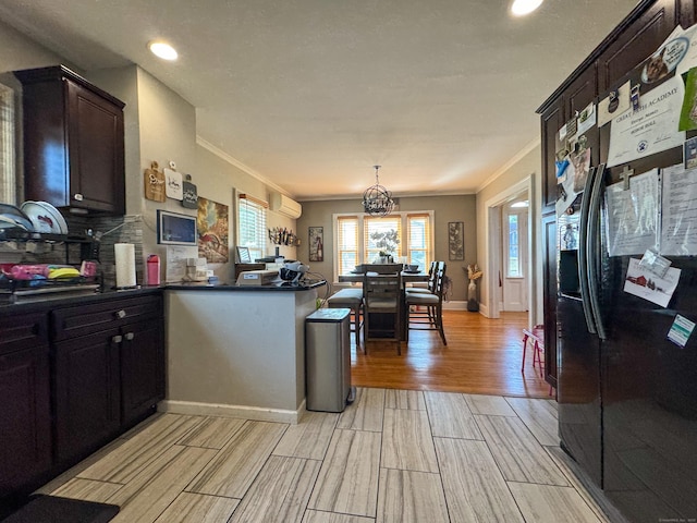 1589 Main St, East Hartford, CT 06108 - kitchen with black fridge with ice dispenser, light wood-style floors, ornamental molding, a peninsula, and dark countertops
