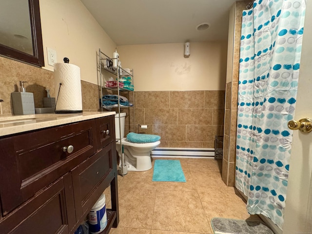 1589 Main St, East Hartford, CT 06108 - bathroom with baseboard heating, tile walls, vanity, tile patterned floors, and wainscoting