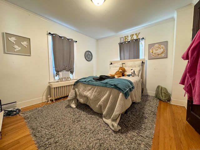 1589 Main St, East Hartford, CT 06108 - bedroom with radiator heating unit, ornamental molding, and wood finished floors