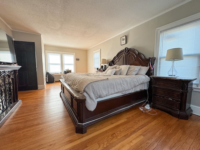 1589 Main St, East Hartford, CT 06108 - bedroom with a textured ceiling, light wood-style flooring, and crown molding