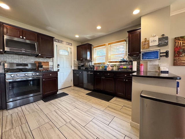 1589 Main St, East Hartford, CT 06108 - kitchen with appliances with stainless steel finishes, backsplash, dark brown cabinetry, and recessed lighting