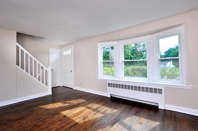 47 Westwood Dr, Simsbury, CT 06070 - entrance foyer featuring radiator heating unit, stairs, and dark wood finished floors