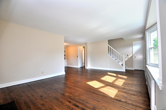 47 Westwood Dr, Simsbury, CT 06070 - unfurnished living room featuring stairs and dark wood-style flooring