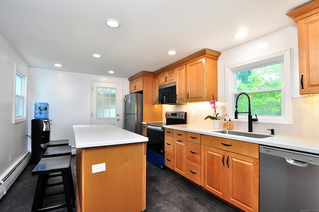 47 Westwood Dr, Simsbury, CT 06070 - kitchen featuring appliances with stainless steel finishes, a center island, backsplash, a breakfast bar area, and light countertops