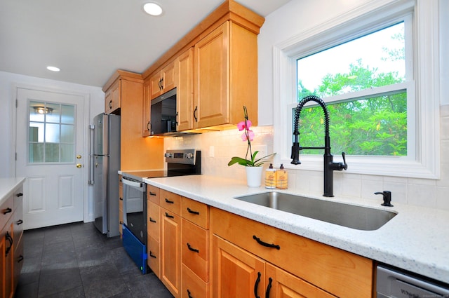 47 Westwood Dr, Simsbury, CT 06070 - kitchen featuring appliances with stainless steel finishes, healthy amount of natural light, backsplash, light stone countertops, and recessed lighting