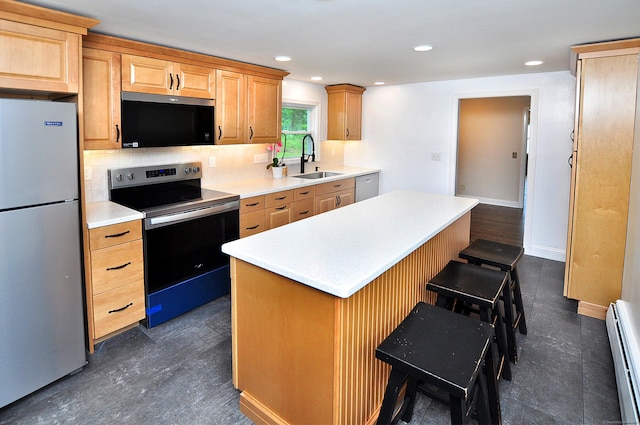 47 Westwood Dr, Simsbury, CT 06070 - kitchen featuring stainless steel appliances, a baseboard radiator, a center island, backsplash, and light countertops