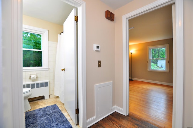 47 Westwood Dr, Simsbury, CT 06070 - bathroom featuring radiator, wood finished floors, and curtained shower