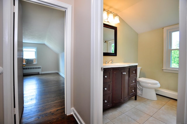 47 Westwood Dr, Simsbury, CT 06070 - bathroom with radiator heating unit, a baseboard heating unit, vaulted ceiling, vanity, and wood finished floors