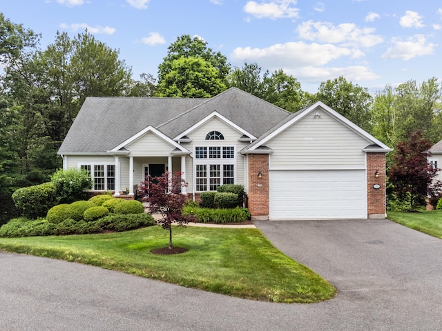 39 Emily Way Unit 39, West Hartford, CT 06107 - view of front of home with driveway, an attached garage, a front lawn, a shingled roof, and brick siding