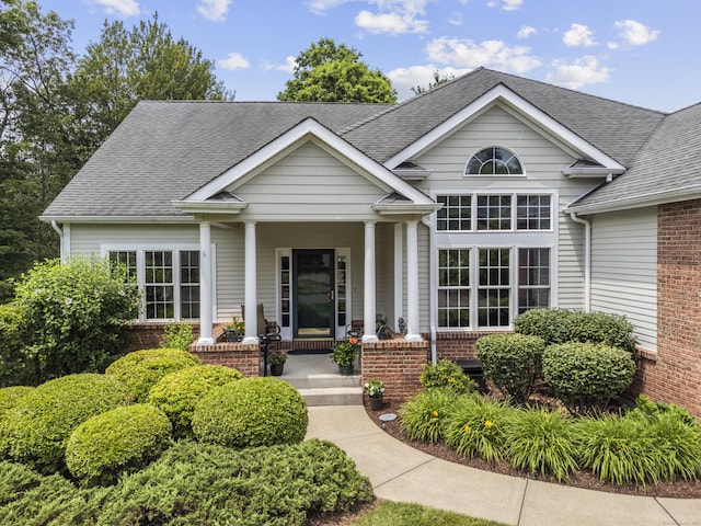 39 Emily Way Unit 39, West Hartford, CT 06107 - view of front of home featuring covered porch, a shingled roof, and brick siding