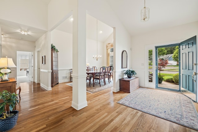 39 Emily Way Unit 39, West Hartford, CT 06107 - foyer featuring high vaulted ceiling, a chandelier, light wood finished floors, and ornate columns