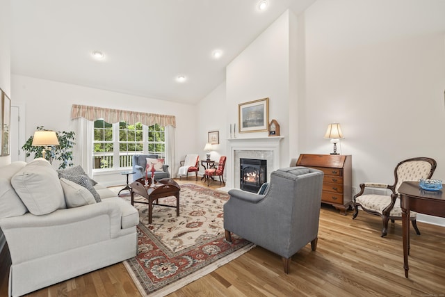 39 Emily Way Unit 39, West Hartford, CT 06107 - living area featuring a tiled fireplace, wood finished floors, high vaulted ceiling, and recessed lighting