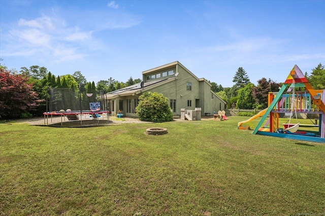 80 Tuckie Rd, Windham, CT 06280 - view of grassy yard with a trampoline, a playground, and an outdoor fire pit