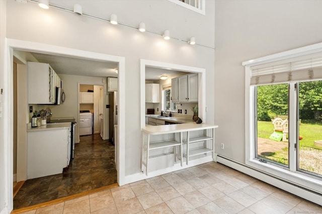 80 Tuckie Rd, Windham, CT 06280 - kitchen featuring a baseboard heating unit, washer / clothes dryer, healthy amount of natural light, and light countertops