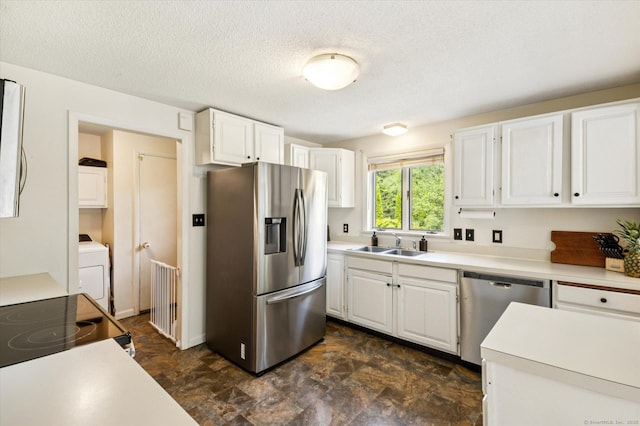 80 Tuckie Rd, Windham, CT 06280 - kitchen featuring stainless steel appliances, washer / clothes dryer, white cabinets, light countertops, and a textured ceiling