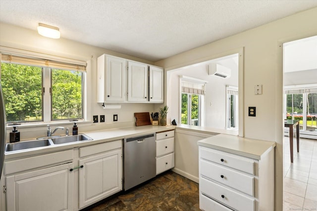 80 Tuckie Rd, Windham, CT 06280 - kitchen with dishwasher, a wall mounted air conditioner, light countertops, white cabinets, and a textured ceiling