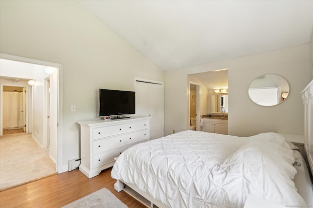 80 Tuckie Rd, Windham, CT 06280 - bedroom with light wood-type flooring, vaulted ceiling, and connected bathroom
