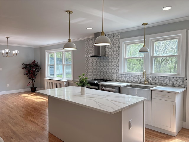 2125 Shepard Ave, Hamden, CT 06518 - kitchen featuring radiator heating unit, decorative backsplash, plenty of natural light, a kitchen island, and ornamental molding
