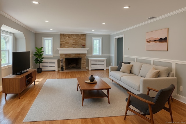 2125 Shepard Ave, Hamden, CT 06518 - living area with healthy amount of natural light, ornamental molding, recessed lighting, light wood-type flooring, and a fireplace