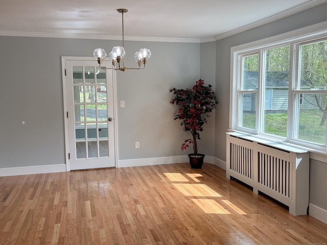 2125 Shepard Ave, Hamden, CT 06518 - unfurnished dining area with radiator, plenty of natural light, a chandelier, light wood finished floors, and crown molding