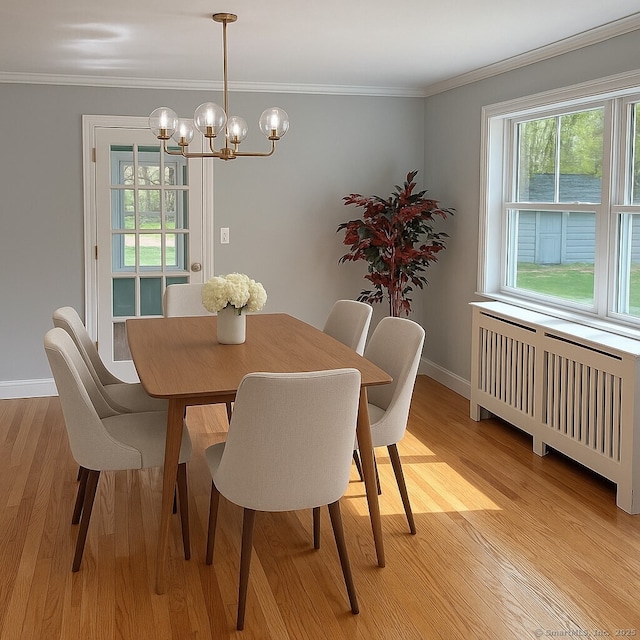 2125 Shepard Ave, Hamden, CT 06518 - dining area featuring radiator, a chandelier, light wood finished floors, and crown molding