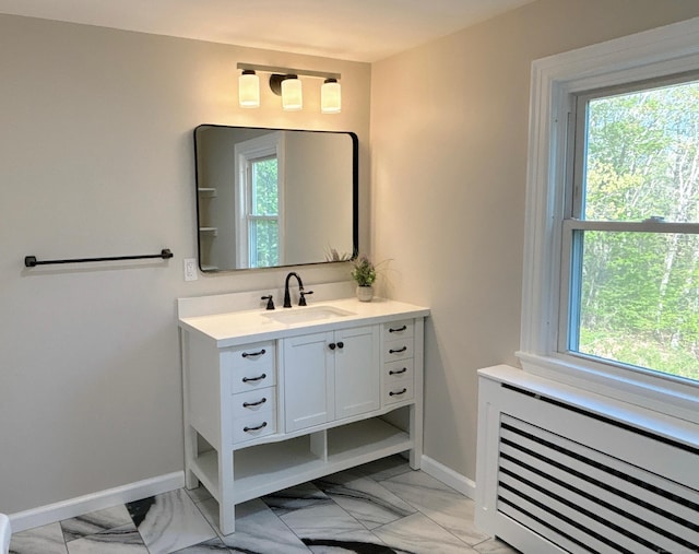 2125 Shepard Ave, Hamden, CT 06518 - bathroom featuring radiator heating unit, vanity, marble look tiles, and healthy amount of natural light
