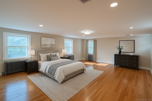 2125 Shepard Ave, Hamden, CT 06518 - bedroom with radiator heating unit, light wood-style flooring, and recessed lighting
