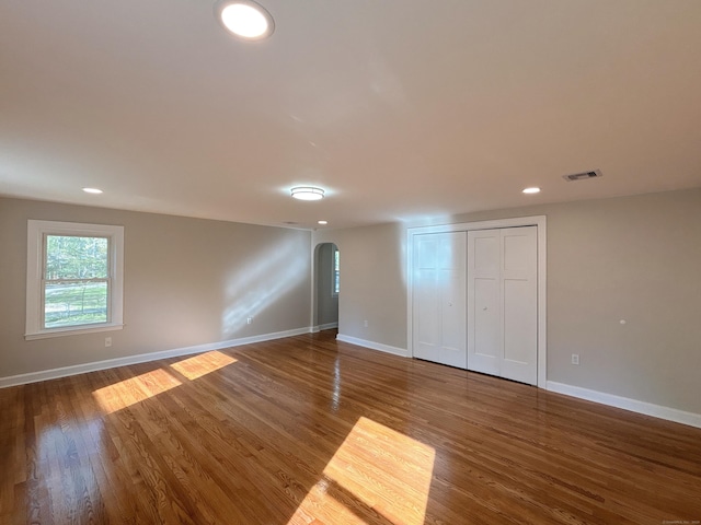 2125 Shepard Ave, Hamden, CT 06518 - unfurnished bedroom with arched walkways, wood finished floors, recessed lighting, and a closet