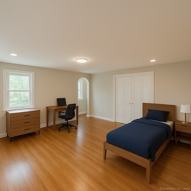 2125 Shepard Ave, Hamden, CT 06518 - bedroom featuring arched walkways, multiple windows, light wood-style flooring, and recessed lighting
