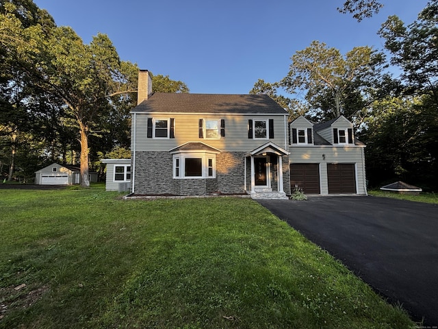 2125 Shepard Ave, Hamden, CT 06518 - view of front of property with driveway, stone siding, a chimney, a front lawn, and a garage