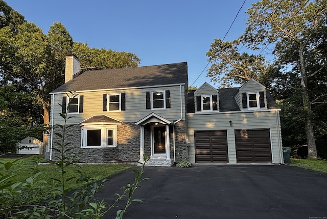 2125 Shepard Ave, Hamden, CT 06518 - view of front facade featuring driveway, a chimney, a garage, and stone siding