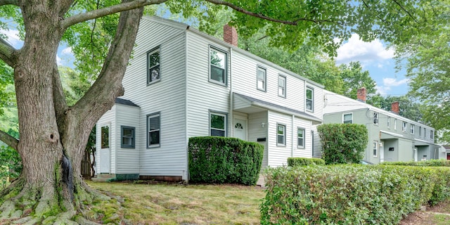 83 Woodlawn Cir E, Hartford, CT 06108 - view of home's exterior featuring a chimney