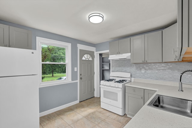 83 Woodlawn Cir E, Hartford, CT 06108 - kitchen with white appliances, under cabinet range hood, gray cabinetry, backsplash, and light countertops