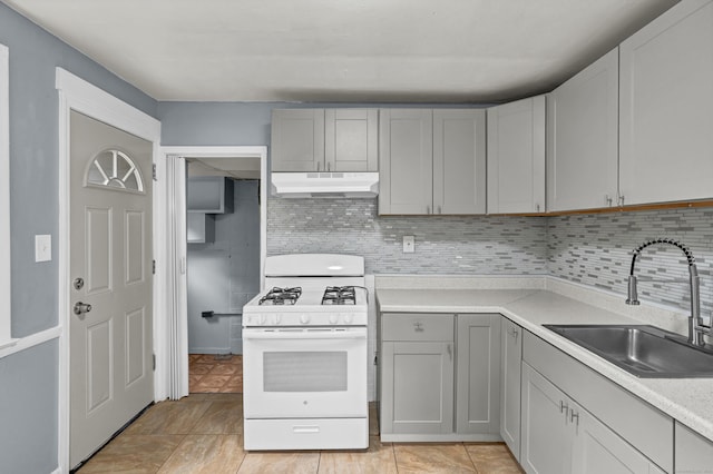 83 Woodlawn Cir E, Hartford, CT 06108 - kitchen featuring gas range gas stove, under cabinet range hood, gray cabinets, backsplash, and light countertops