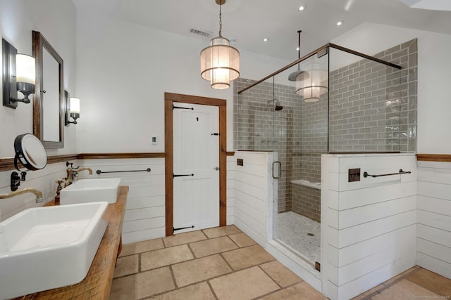2024 Stratfield Rd, Fairfield, CT 06825 - bathroom with a stall shower, recessed lighting, double vanity, wainscoting, and stone finish flooring