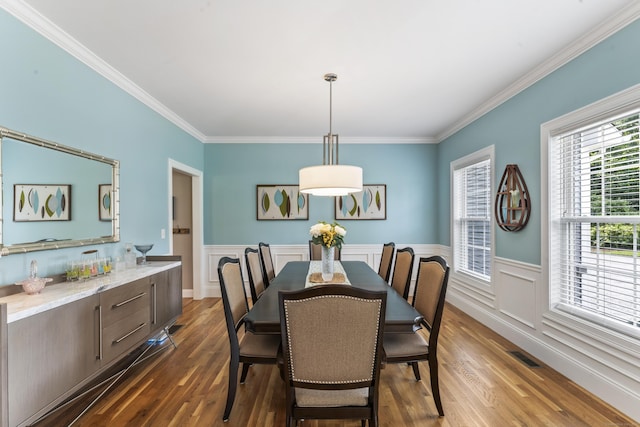 233 Ichabod Rd, Southbury, CT 06488 - dining area with crown molding, dark wood-style flooring, and a wainscoted wall