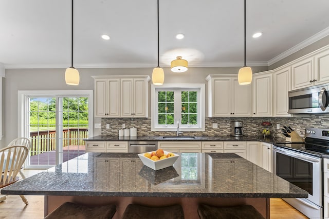 233 Ichabod Rd, Southbury, CT 06488 - kitchen featuring appliances with stainless steel finishes, a kitchen breakfast bar, decorative backsplash, healthy amount of natural light, and ornamental molding