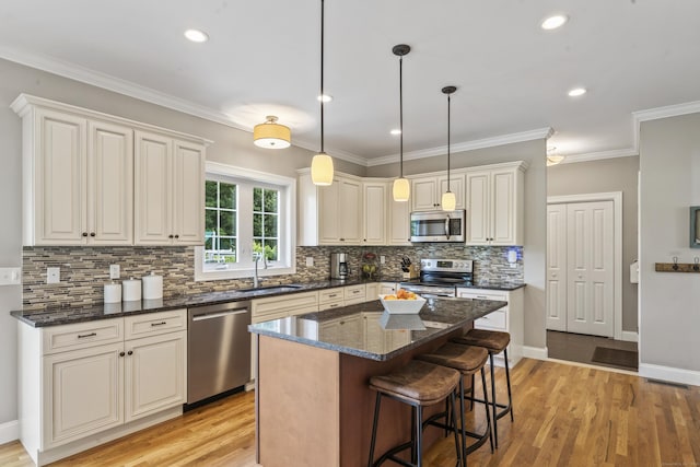 233 Ichabod Rd, Southbury, CT 06488 - kitchen featuring stainless steel appliances, tasteful backsplash, a center island, decorative light fixtures, and ornamental molding