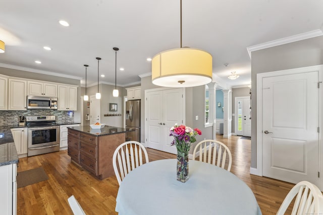 233 Ichabod Rd, Southbury, CT 06488 - dining room with crown molding, wood finished floors, ornate columns, and recessed lighting
