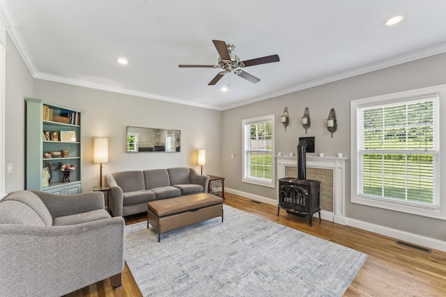 233 Ichabod Rd, Southbury, CT 06488 - living area featuring a wood stove, ceiling fan, wood finished floors, crown molding, and recessed lighting