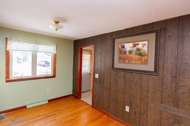 234 Vergason Ave, Norwich, CT 06360 - spare room featuring a baseboard heating unit, plenty of natural light, light wood finished floors, and wooden walls
