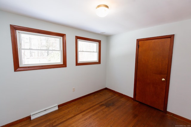 234 Vergason Ave, Norwich, CT 06360 - unfurnished room with a baseboard heating unit and dark wood-style floors