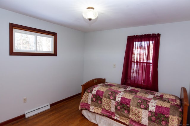 234 Vergason Ave, Norwich, CT 06360 - bedroom with baseboard heating, multiple windows, and wood finished floors