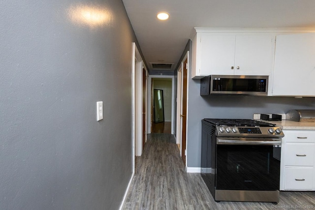 136 Chatham St, Hartford, CT 06112 - kitchen featuring appliances with stainless steel finishes, wood finished floors, white cabinets, and light countertops