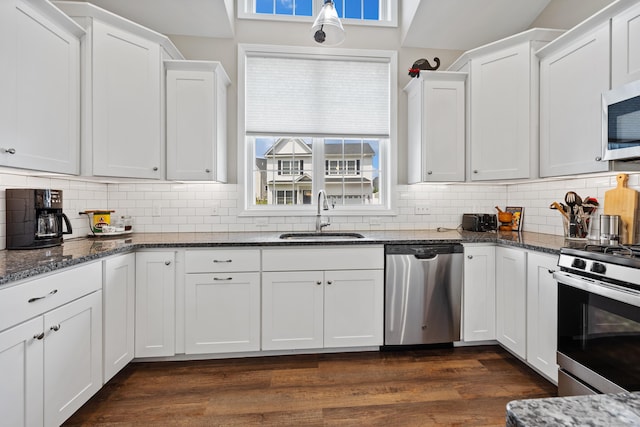 31 Old Oak Ct, Southington, CT 06489 - kitchen featuring stainless steel appliances, white cabinetry, plenty of natural light, and decorative backsplash